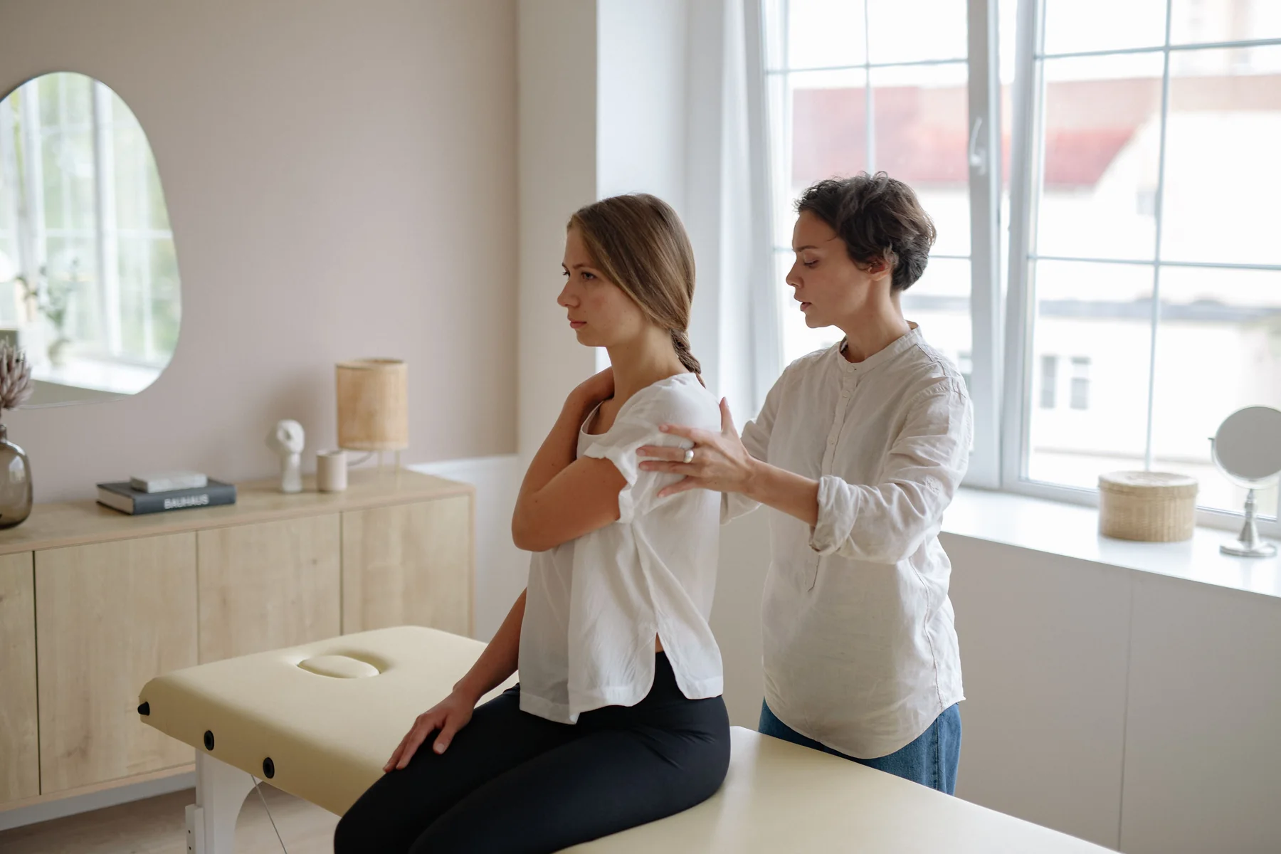 Professional shoulder massage in a bright modern studio